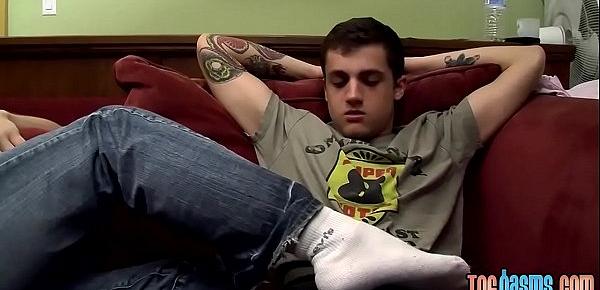  Tattooed twink gets a footjob before getting to blow cock
